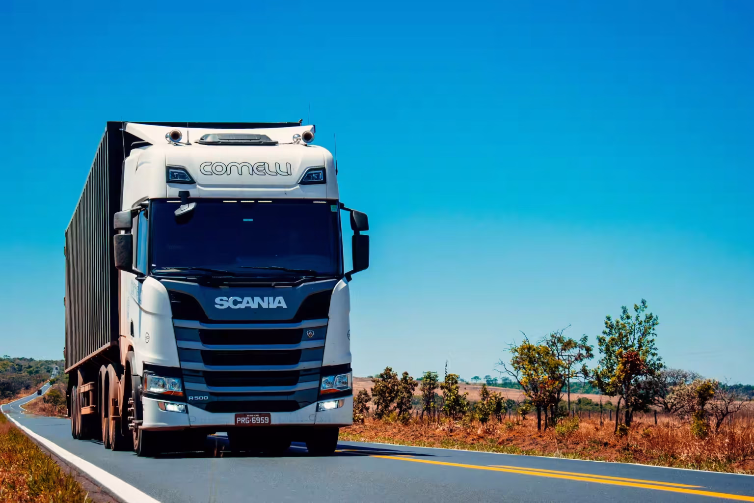 Heavy-duty freight truck transporting cargo on highway for regional road freight distribution.