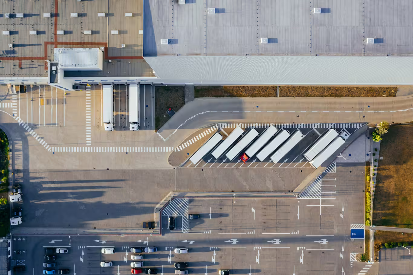 Delivery trucks loading at distribution centre for scheduled domestic transport across South Africa.