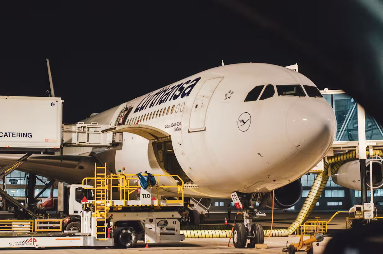 Cargo aircraft being loaded at airport terminal for international air freight transport.